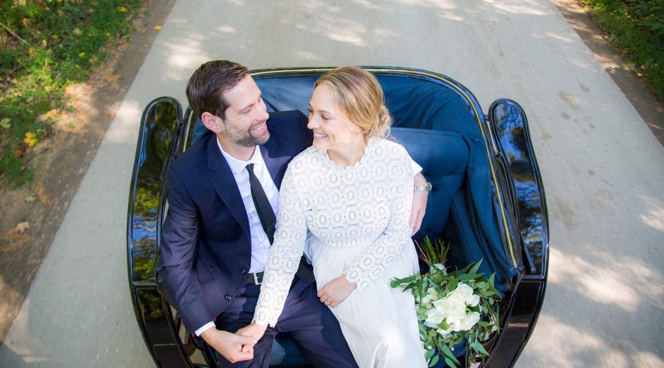 A newly-married couple in a carriage