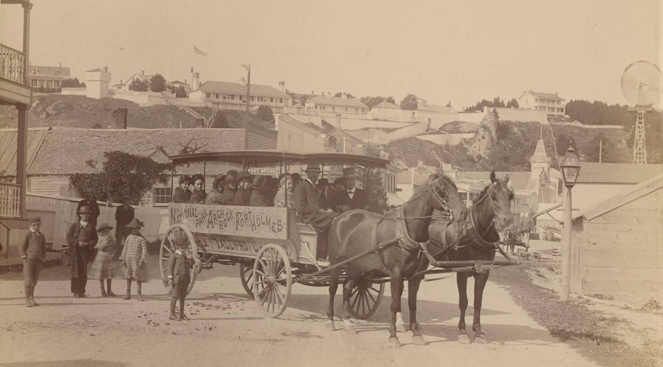 An old black and white photo of a horse-drawn carriage
