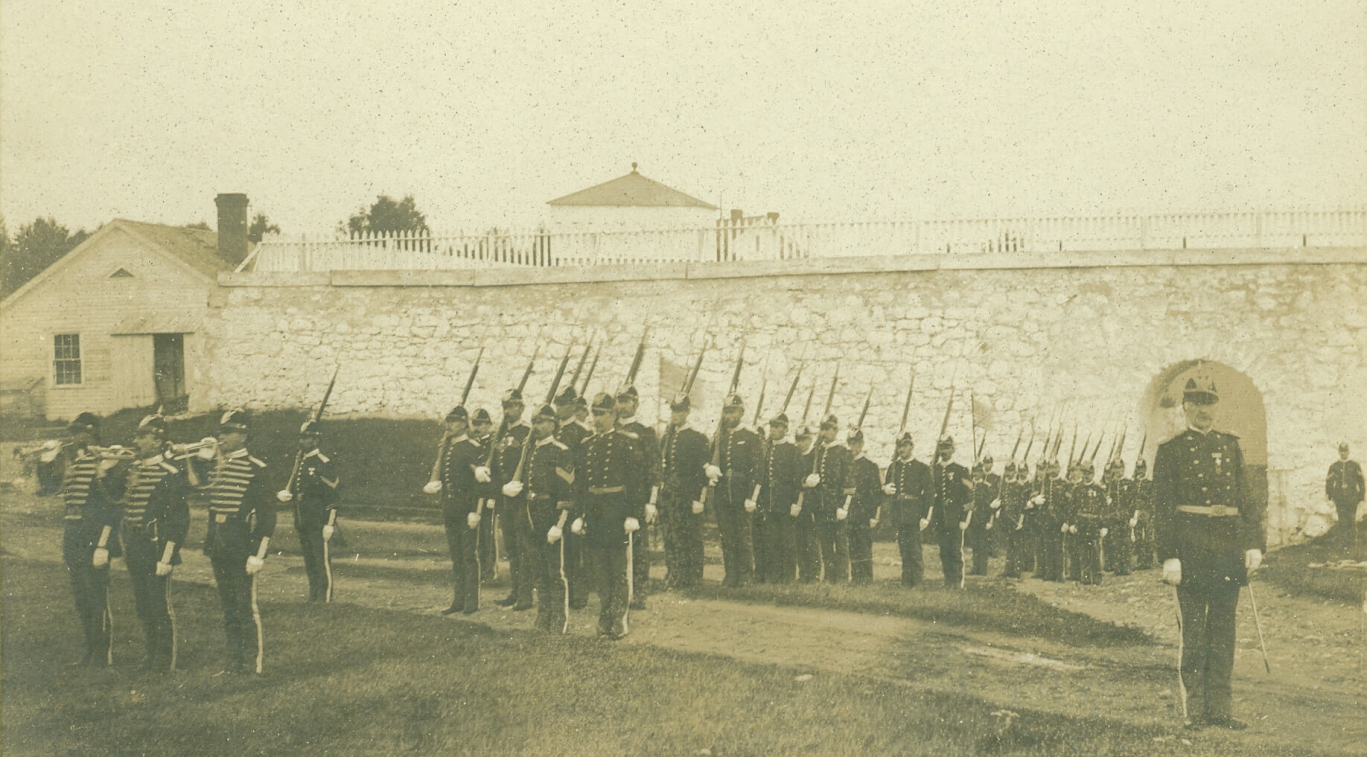 An old black and white photo of soldiers during a parade